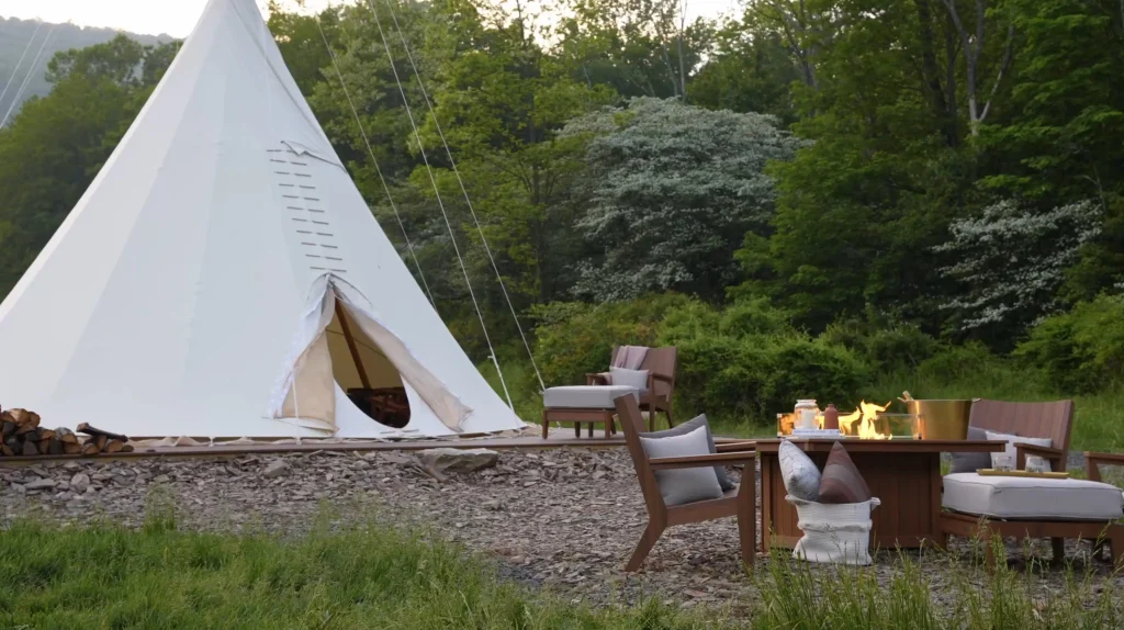 Poly outdoor chair and fire pit table beside a teepee