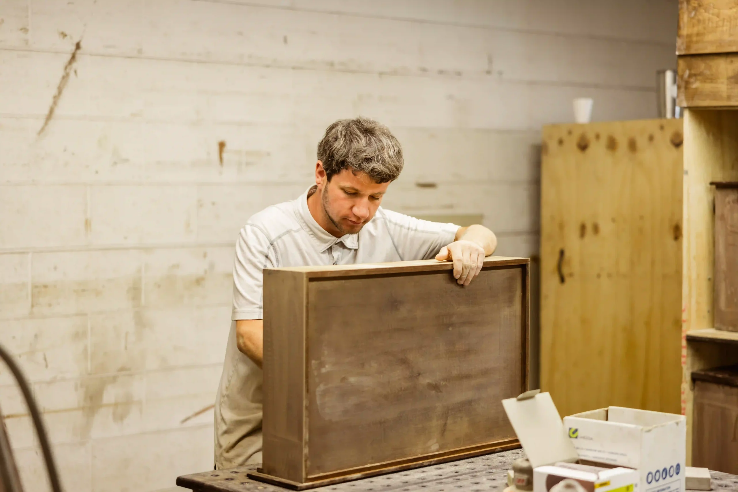 Amish craftsman working on a drawer