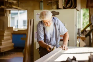 Amish craftsman hand-crafting furniture in traditional workshop