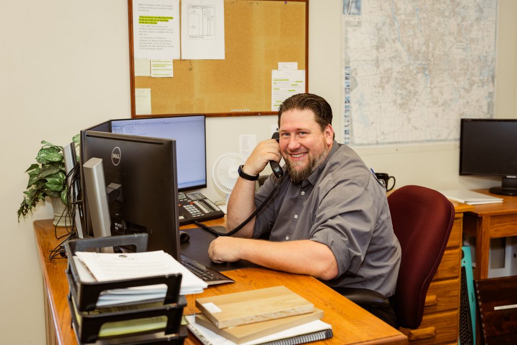 Millwest Amish Furniture team member taking a customer call at the Plain City, Ohio showroom