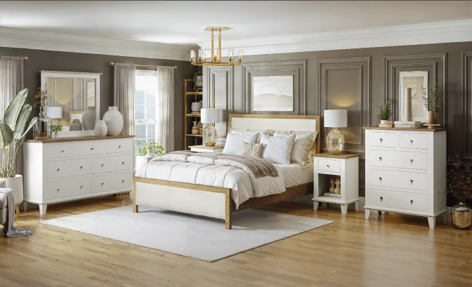 Styled bedroom featuring a Sunrise Cabinets solid hardwood set: upholstered panel bed, dresser with mirror, chest, and nightstands