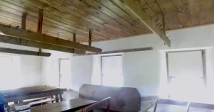 Original 1855 wooden benches and hat racks inside Alleghany Mennonite Meetinghouse, an example of the history of Amish furniture still in use